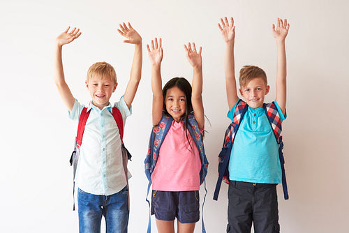 Children on white bakcground with hands up