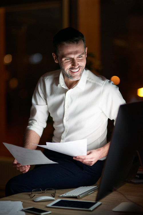 Man analyzing document at night