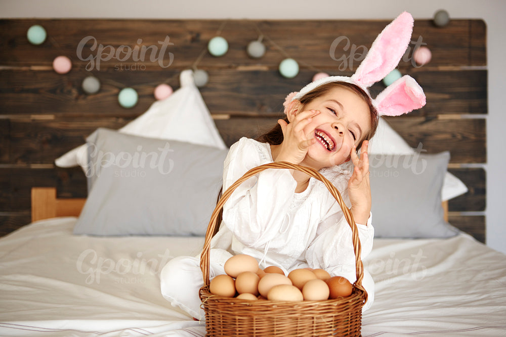 Happy girl with a basket of eggs