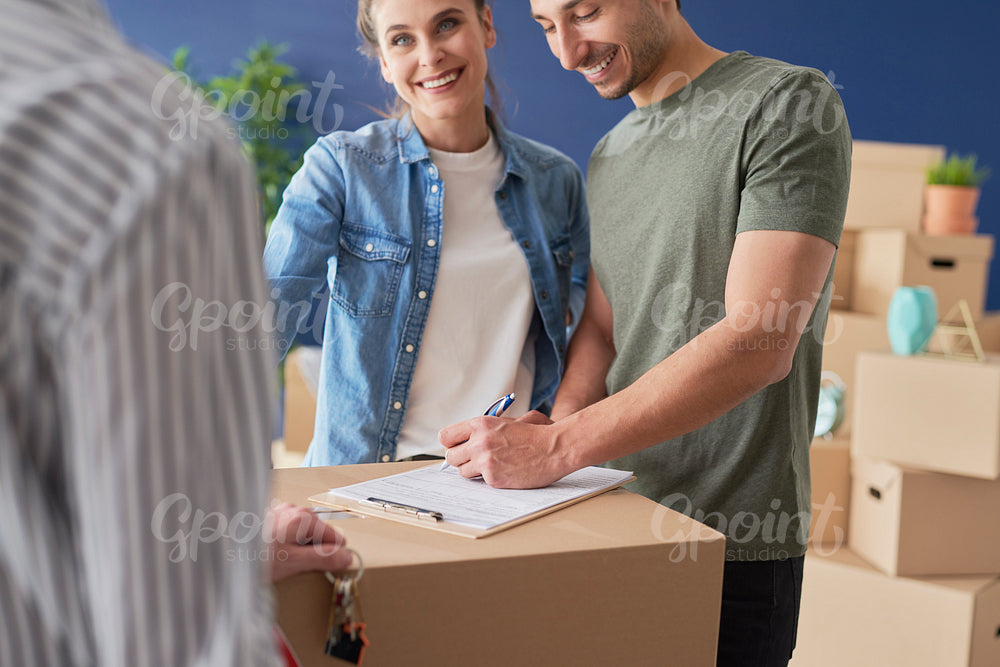 Couple signing a house purchase agreement