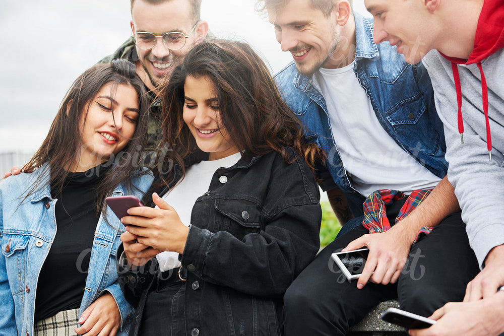Group of young people looking at mobile phone