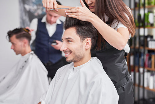 Side view of man has cutting hair at the hairstylist