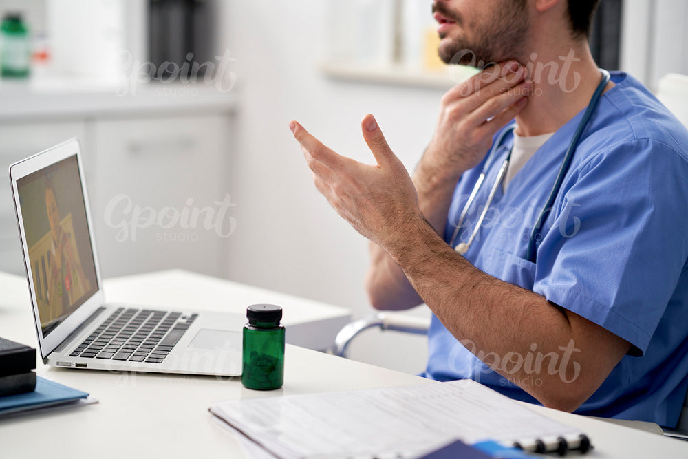 Patient on a video call with a doctor through a laptop