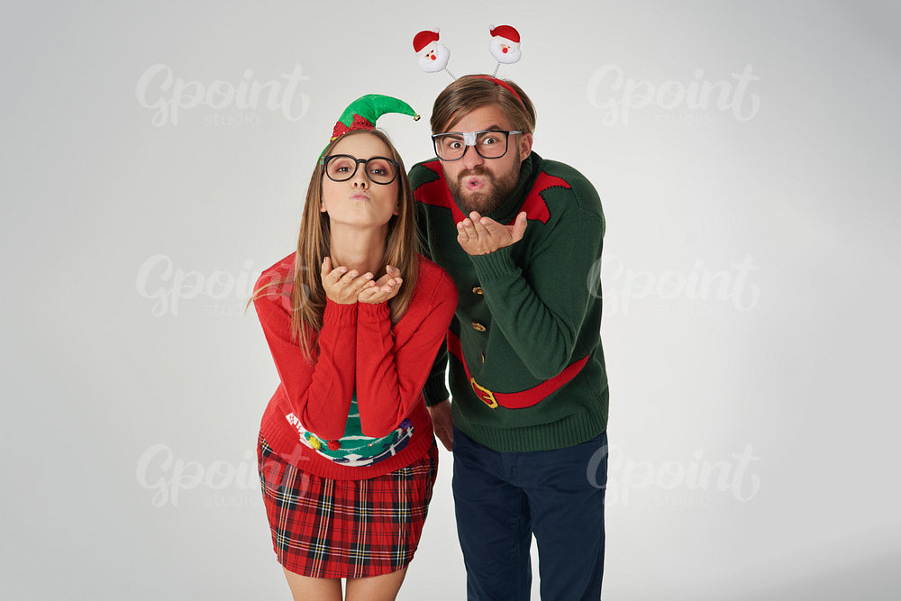 Couple blowing some Christmas kisses