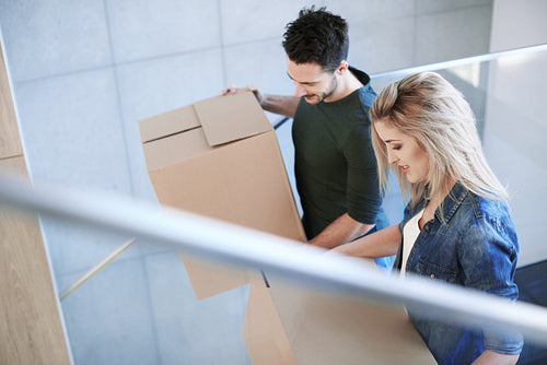 Cheerful couple moving into new flat