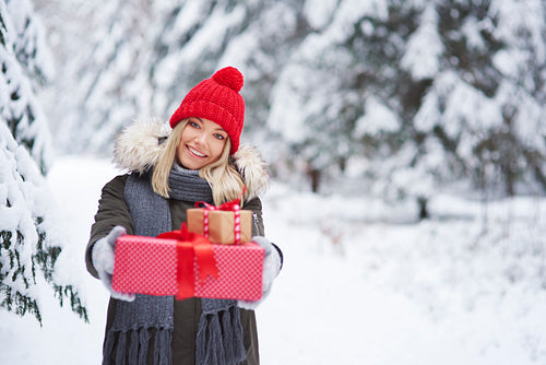 Portrait of smiling woman giving two Christmas presents