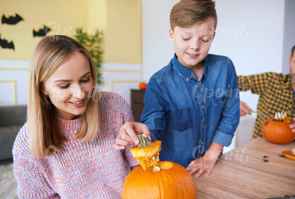 Parent and child making carved pumpkin