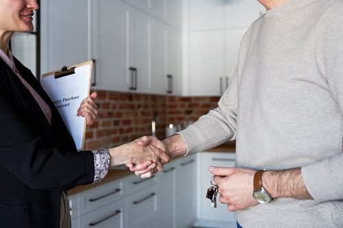 Close up of estate agent in the handshake of a customer