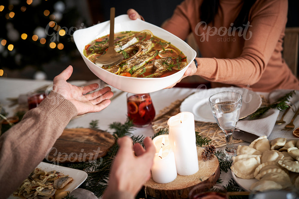 Women sharing a food with family at Christmas Eve
