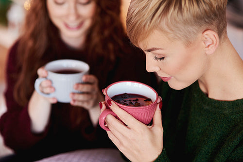 Girl drinking hot tea or mulled wine
