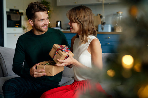 Couple exchanging gifts on Christmas time