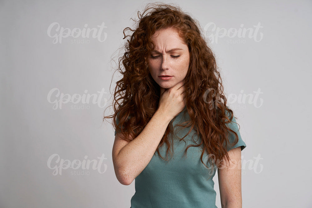 Young woman with serious sore throat