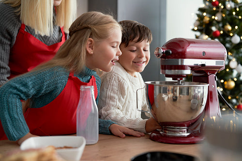 Curious children looking into electric mixer