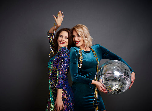 Two women with disco ball partying