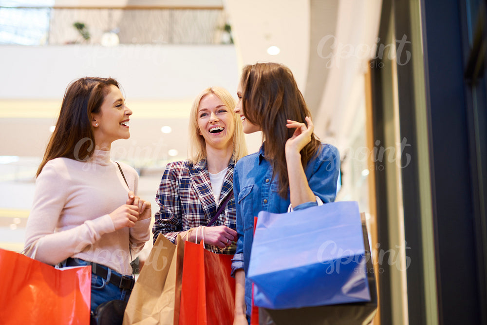 Three girls enjoying the shopping in the shopping mall