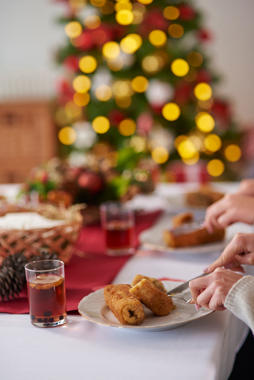 People eating croquettes during the Christmas Eve