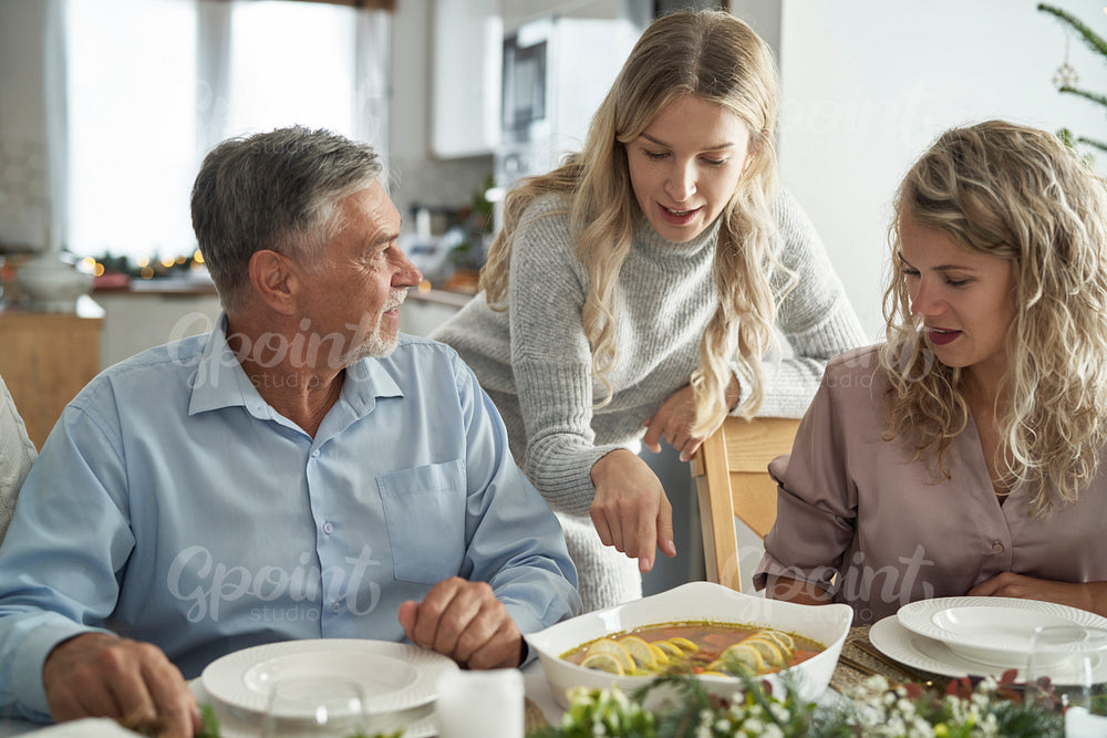 Caucasian family discussing over food served on Christmas Eve