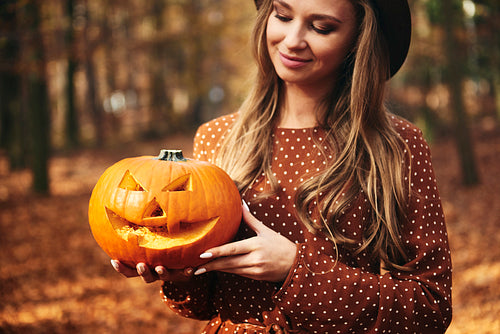 Woman holding spooky pumpkin for Halloween