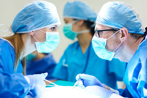 Two surgeons having conversation over operating table