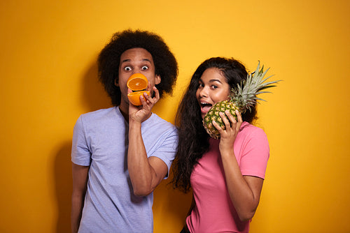 African couple with exotic fruits