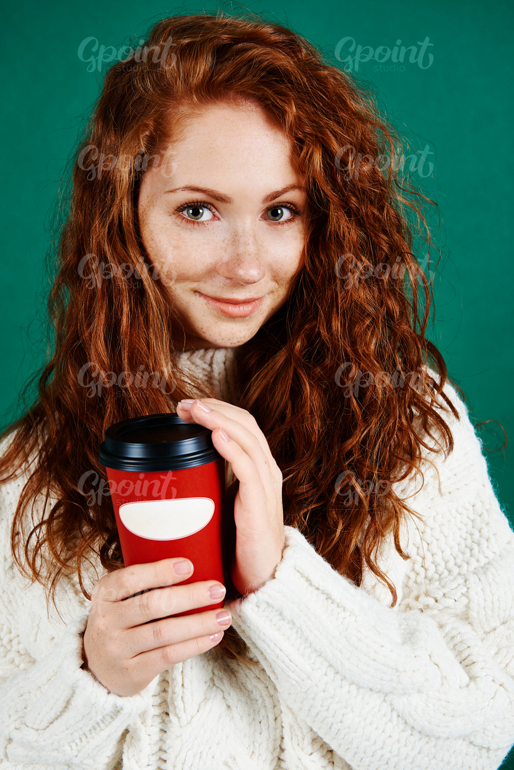 Beautiful woman holding disposable mug of coffee