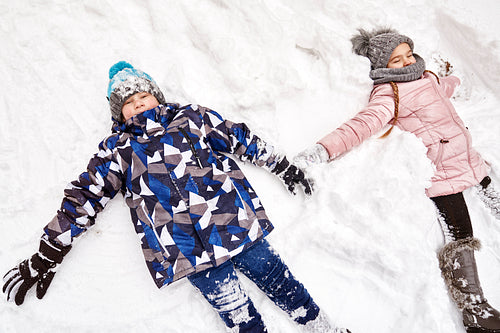 Two children making snow angels