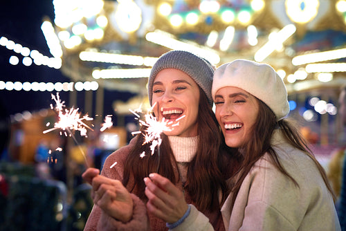 Best friends with sparklers on Christmas market