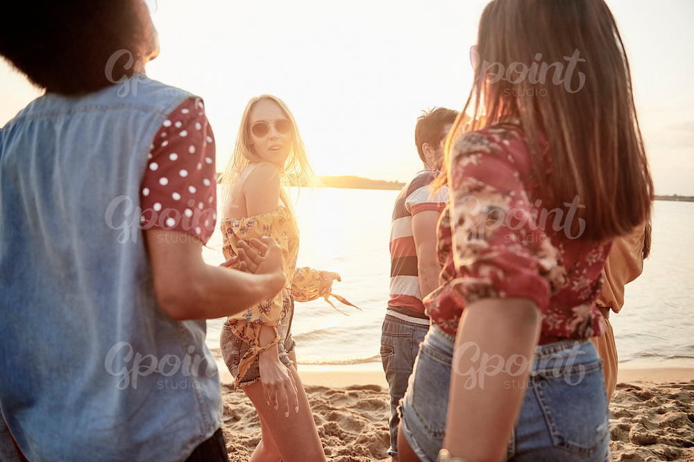 Young people dancing on the beach