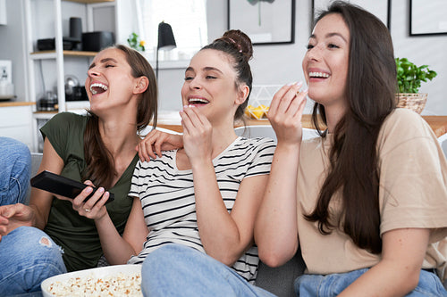 Best friends watching comedy movie at home