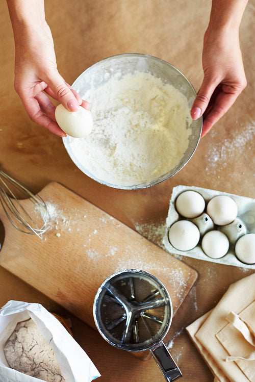 Hands of woman and baking ingredients