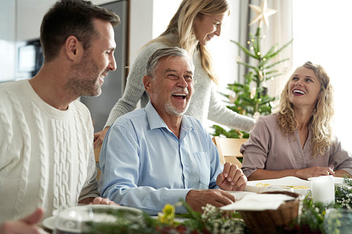 Cheerful caucasian family spending time over table at Christmas dinner