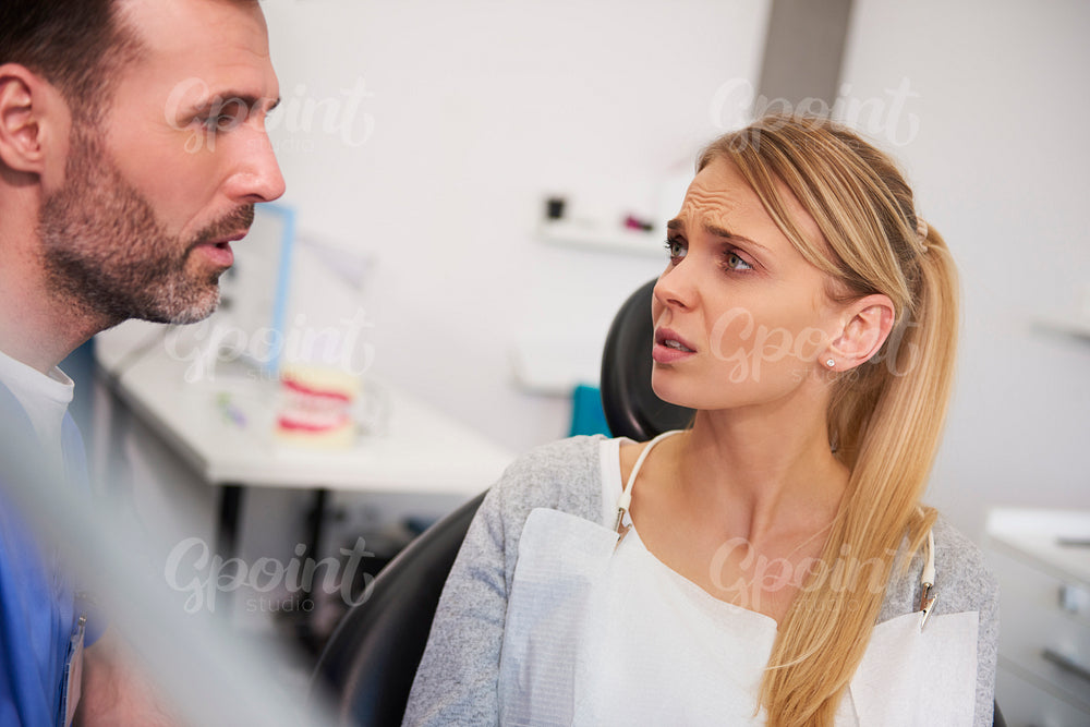 Terrified woman looking at male dentist