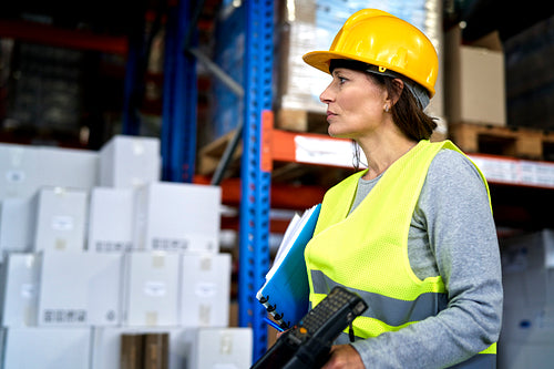 Adult caucasian woman working in warehouse
