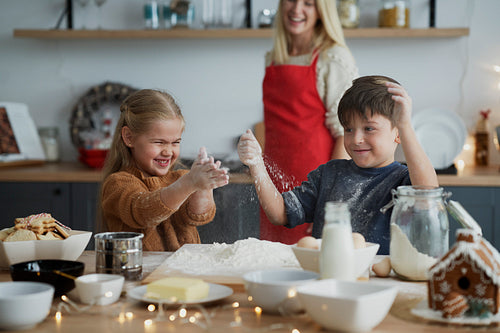 Children having fun while preparing pastry for Christmas cookies