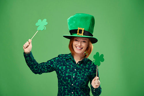 Portrait of woman with leprechaun's hat and clover shaped banner
