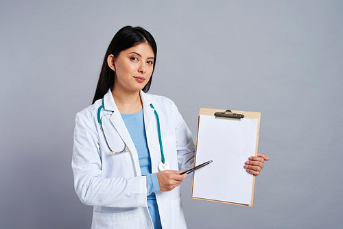 Doctor pointing on empty piece of paper