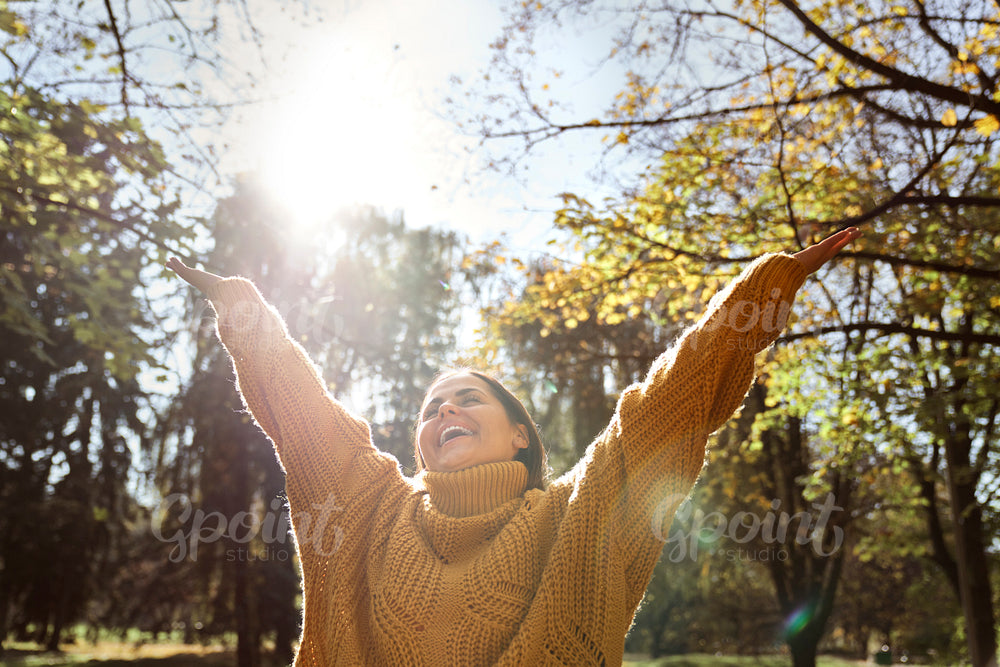 Caucasian woman with eyes closed smiling at the park in autumn 