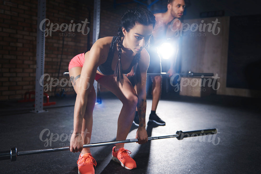Confident couple training at gym