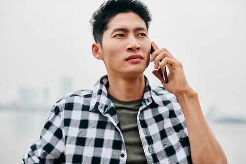 Young Vietnamese man is on the phone