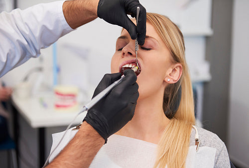 Stomatologist giving woman anesthesia in dentist's clinic