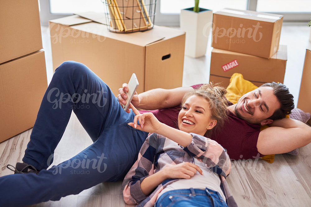 Young couple taking break from moving home