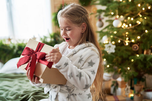 Little girl opening the Christmas present
