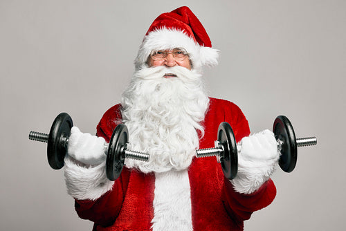Caucasian Santa Claus with large dumbbells