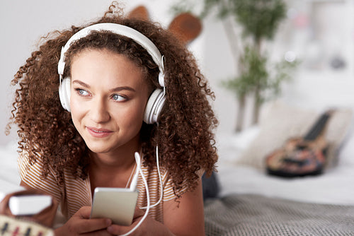 Beautiful young woman listening to music