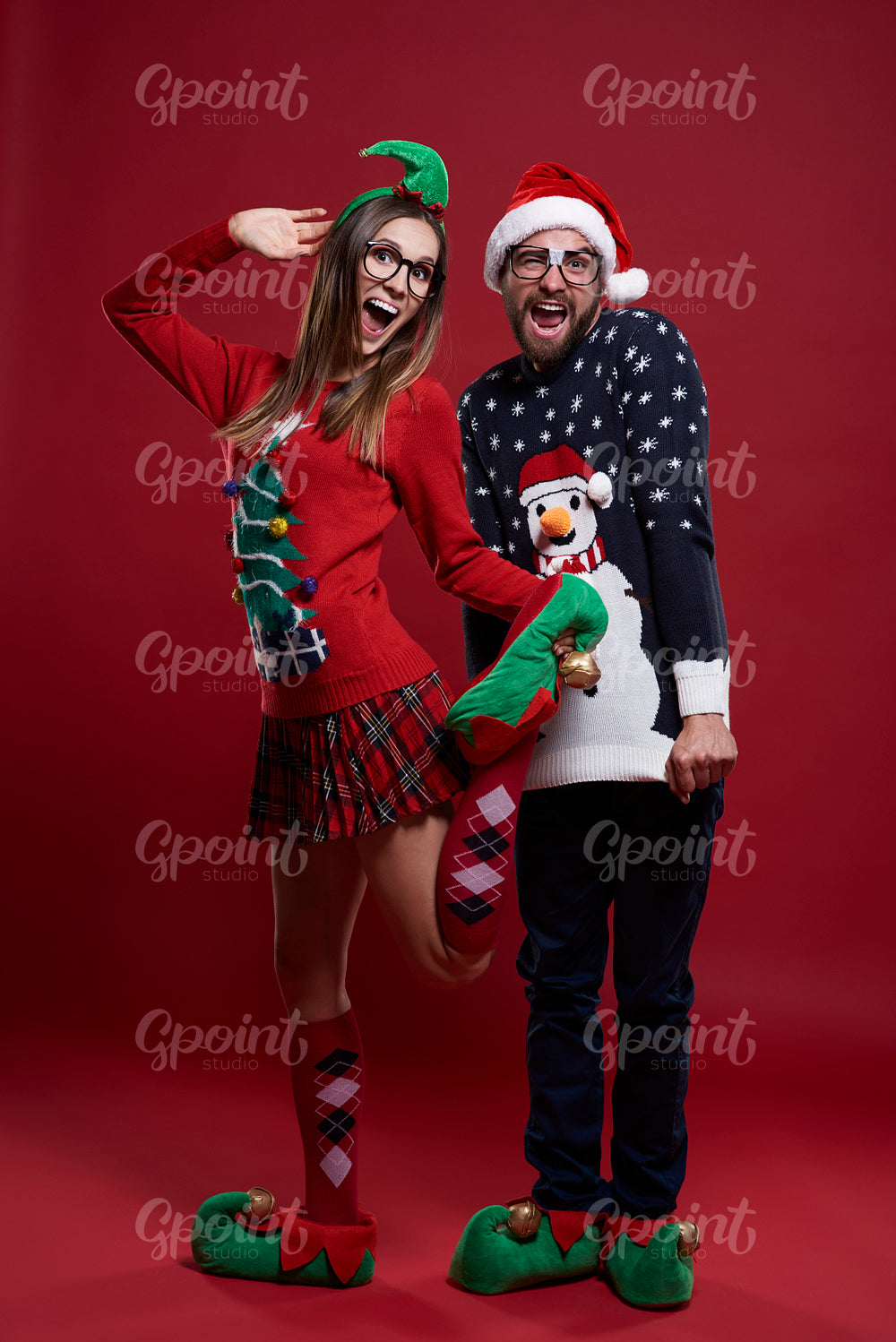 Young couple in funny Christmas clothes