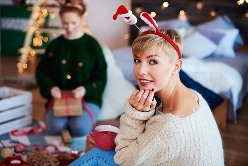 Portrait of young woman spending christmas time in bedroom