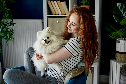 Fluffy pet dog and his redhead owner