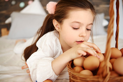 Focused girl watching the eggs