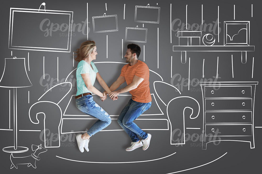 Couple holding hands against furniture background