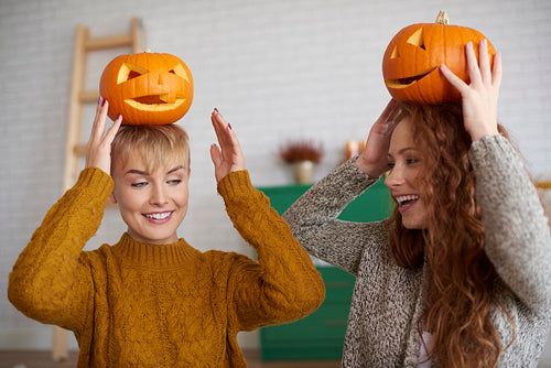 Girls having fun with halloween pumpkins